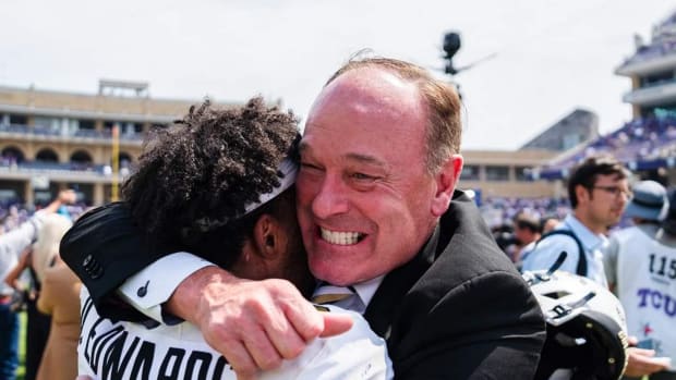 Rick George hugging Dylan Edwards after big win at TCU